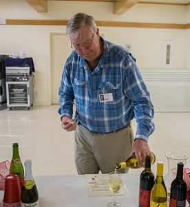 Tom Fischer pouring wine