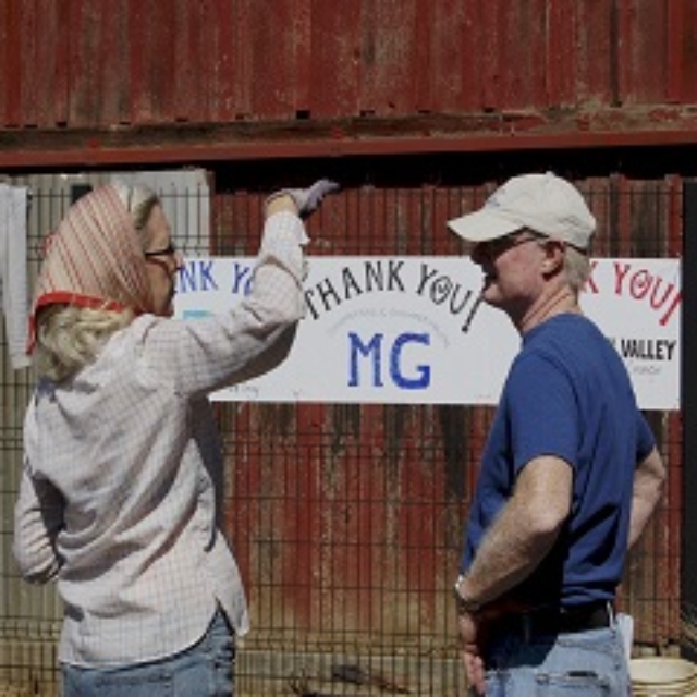 man,woman,talking,hat,scarf,sign,barn